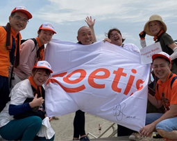 Colleagues hold a white Zoetis flag